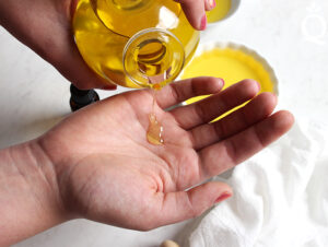 A man preparing oils for a erotic massage in east london